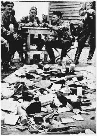 Ustasa men look over loot taken from prisoners at Jasenovac